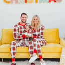 Man & Women Sitting wearing red and white stripe pajamas with baby